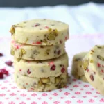 Cranberry pistachio shortbread cookies stacked on plate