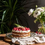 Pistachio raspberry cake slice with berries and nuts