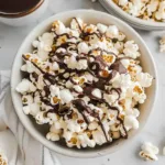Bowl of freshly Chocolate covered popcorndrizzled with melted dark chocolate
