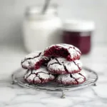 Red Velvet Crinkle Cookies fresh from the oven with powdered sugar coating