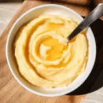 Whipped honey butter in a rustic bowl on wooden table
