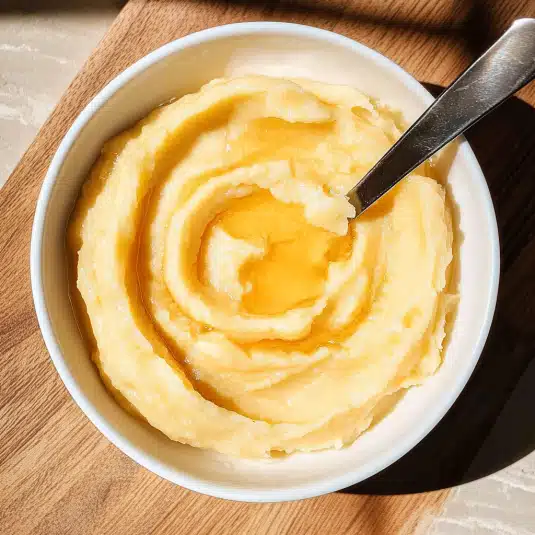 Whipped honey butter in a rustic bowl on wooden table