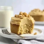 Frosted vanilla cupcake with creamy peanut butter cream cheese frosting topped with chopped peanuts
