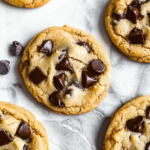 Soft and Best Chocolate Chip Cookies with melted chocolate chunks on a marble surface